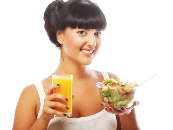 Cheerful young woman has breakfast salad from vegetables with o — Stock Photo, Image