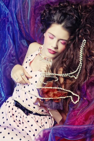 Woman lying on organza with pearl — Stock Photo, Image