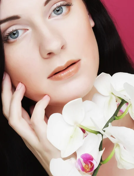 Beautiful healthy woman with orchid flower. — Stock Photo, Image