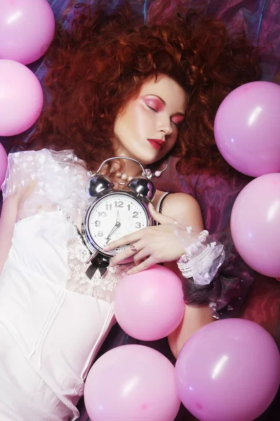 Woman lying on floor among balloons — Stock Photo, Image