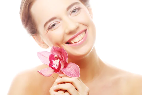 Frau mit rosa Orchidee — Stockfoto