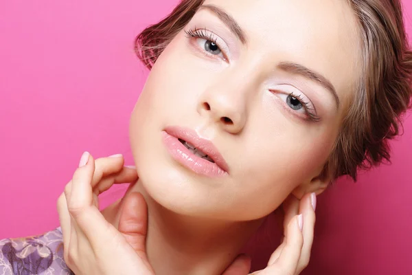 Young woman over pink background — Stok fotoğraf