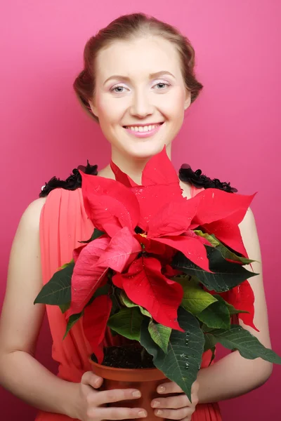 Woman with poinsettia — Stock Photo, Image