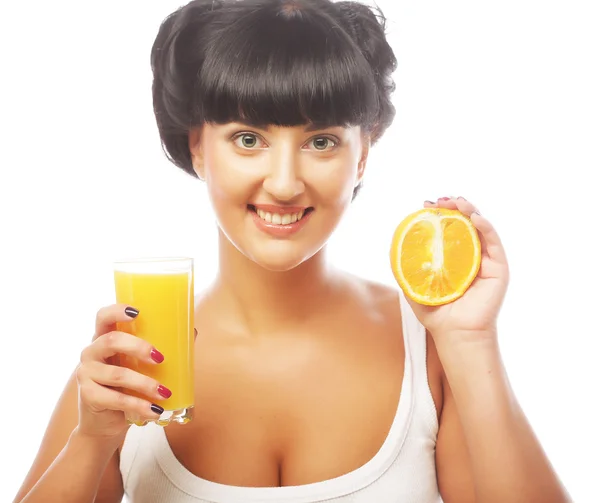 Brunette woman holding orange juice — Stock Photo, Image