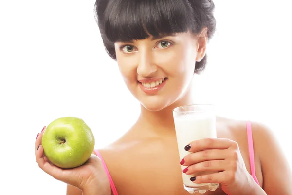 Woman with apple and milk — Stock Photo, Image