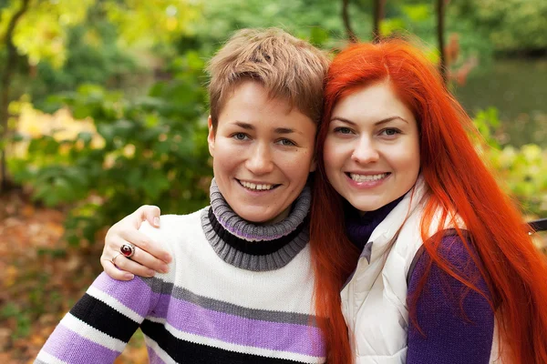 Two pretty girls walking in autumn park — Stock Photo, Image