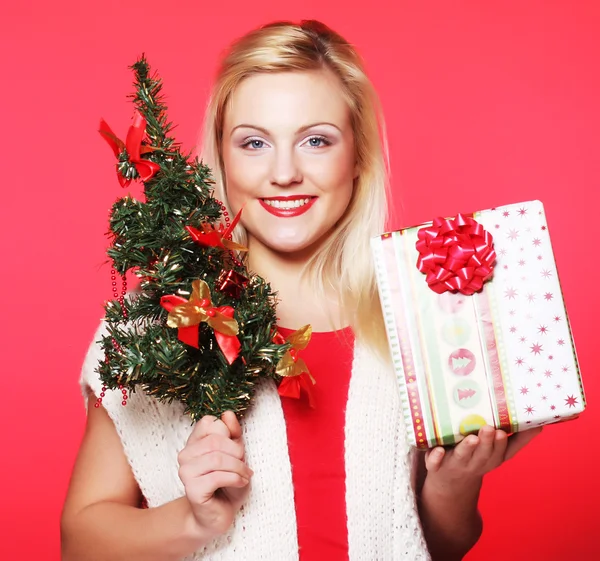 Mujer sosteniendo regalo y el árbol —  Fotos de Stock