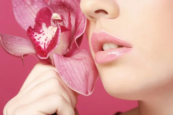 Woman with orchid flower — Stock Photo, Image