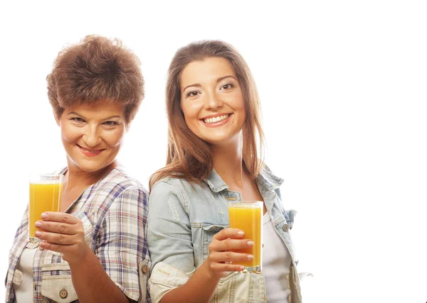 Two women with orange juice. — Stock Photo, Image