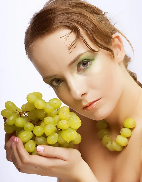 Attractive woman with bunch of grapes — Stock Photo, Image