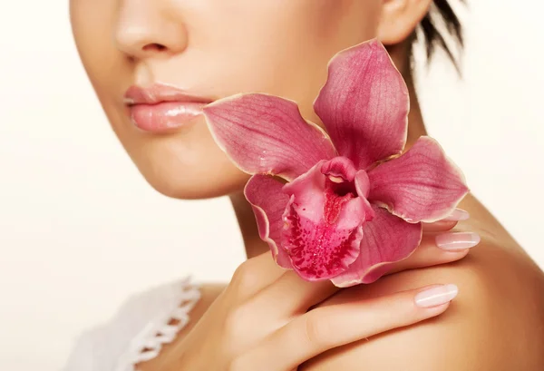 Girl holding orchid flower Stock Image