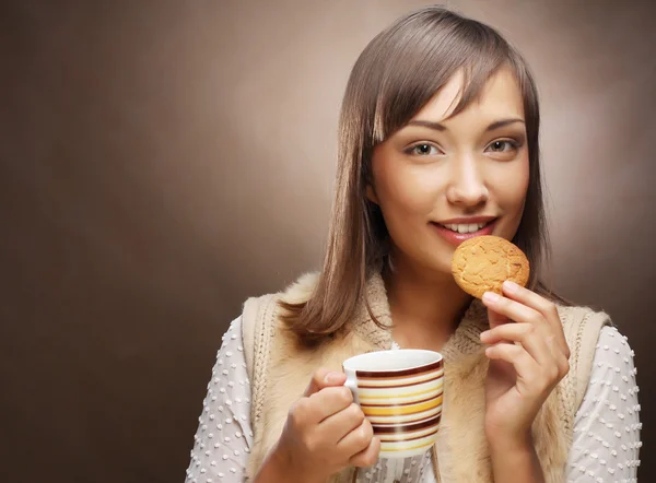 Giovane donna con caffè e biscotti — Foto Stock