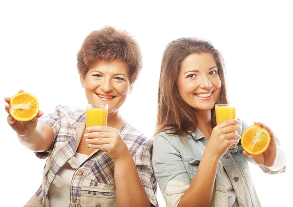 Two women with orange juice. — Stock Photo, Image