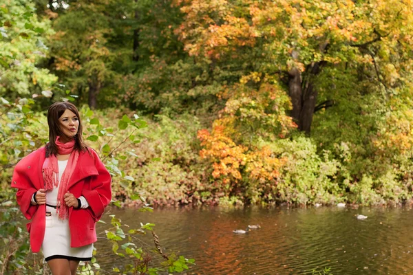 Woman near the river in autumn season — Stock Photo, Image