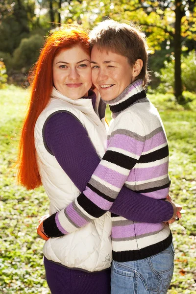 Dos chicas guapas caminando en el parque de otoño — Foto de Stock