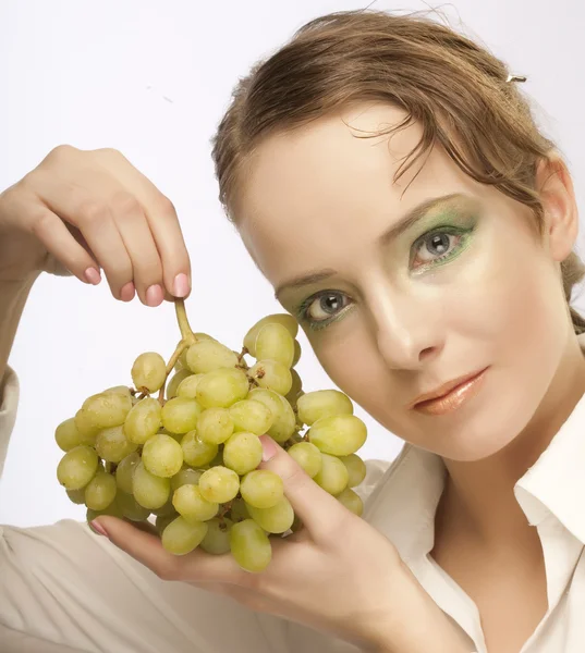 Attractive woman with bunch of grapes — Stock Photo, Image