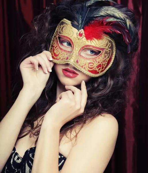 Young woman in a red mysterious mask Royalty Free Stock Photos