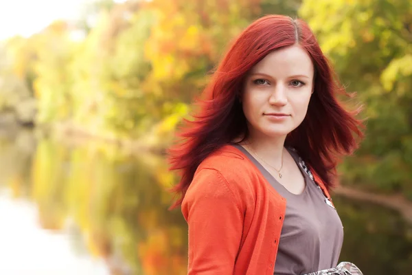 Gelukkige vrouw in de buurt van de rivier in het najaar — Stockfoto