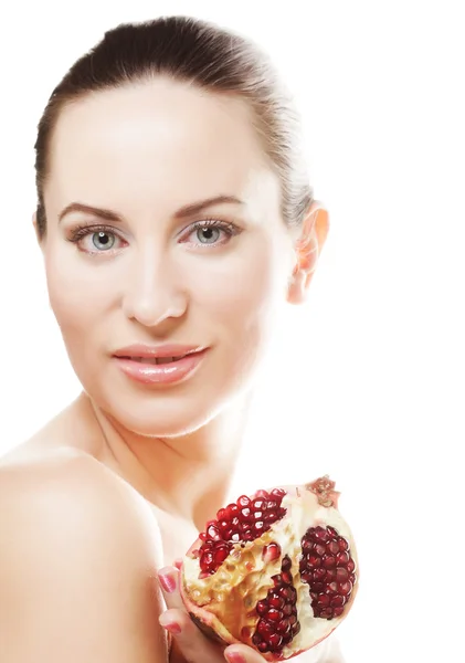 Woman showing pomegranate smiling. — Stock Photo, Image