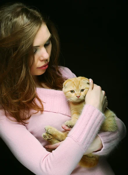 Young woman with red England lop-eared kitten — Stock Photo, Image