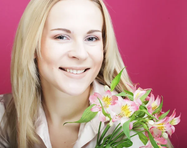 Young beautiful woman with pink flowers — Stock Photo, Image