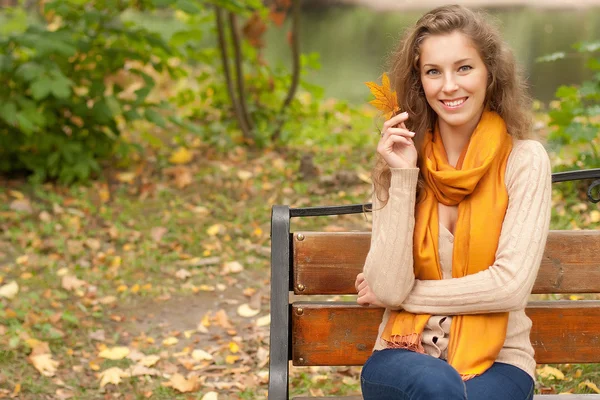 Молодая элегантная женщина с осенними листьями — стоковое фото