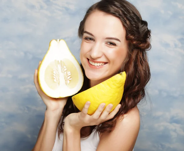 Girl holds in really big citrus fruit - pamelo, — Stock Photo, Image