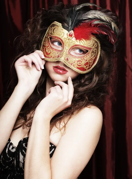 Young woman in a red mysterious mask Stock Photo
