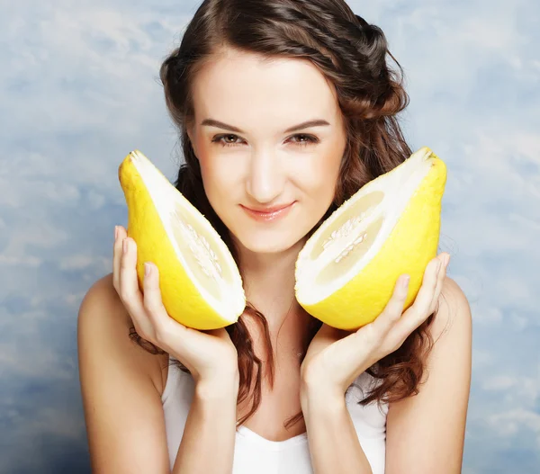 Girl holds in really big citrus fruit - pamelo — Stock Photo, Image