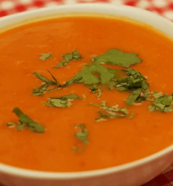 Pumpkin soup in white bowl with parsley — Stock Photo, Image