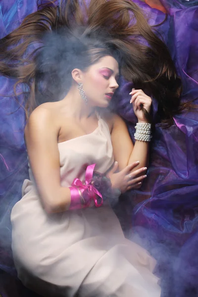 Beautiful woman lay on organza. Sleeping beauty. — Stock Photo, Image