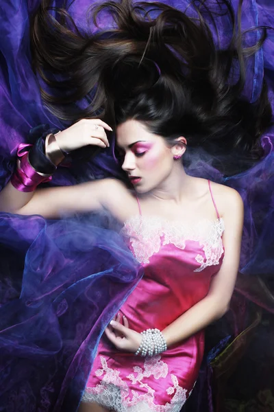 Beautiful woman lay on organza. Sleeping beauty. — Stock Photo, Image