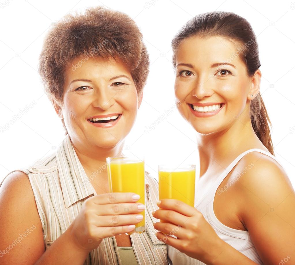 Two women with orange juice.