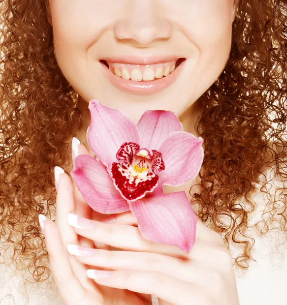 Beautiful woman with pink flower — Stock Photo, Image