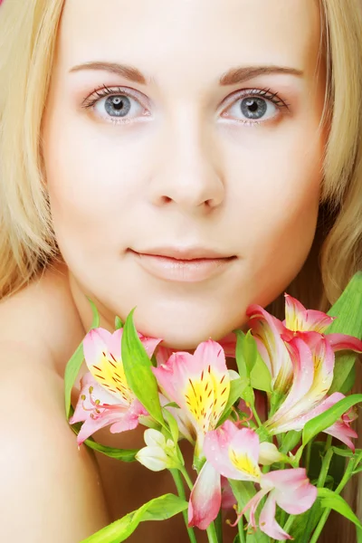 Young beautiful woman with pink flowers Royalty Free Stock Photos