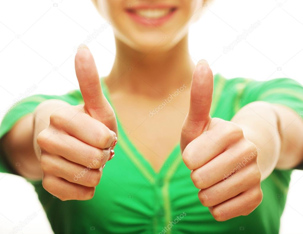 Casual girl showing thumbs up and smiling