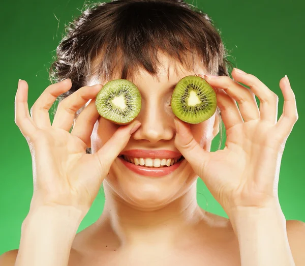 Joven mujer sonriente sosteniendo kiwi . —  Fotos de Stock