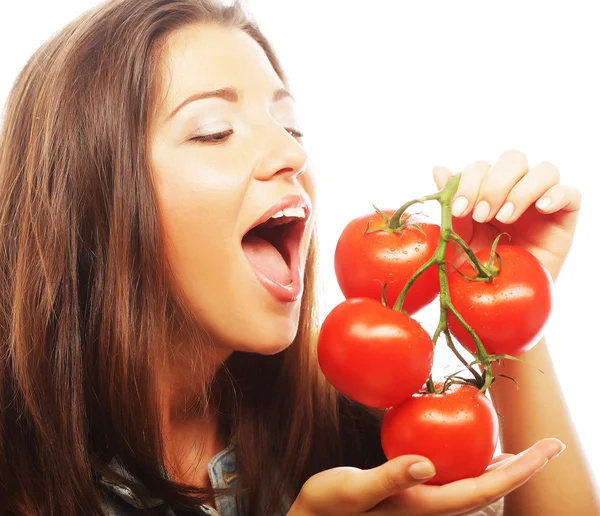 Beautiful young woman with ripe tomatoes — Stock Photo, Image