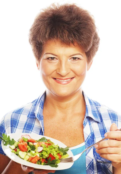 Mature smiling woman eating salad — Stock Photo, Image