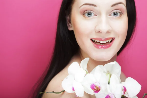 Beautiful healthy woman with orchid flower. — Stock Photo, Image