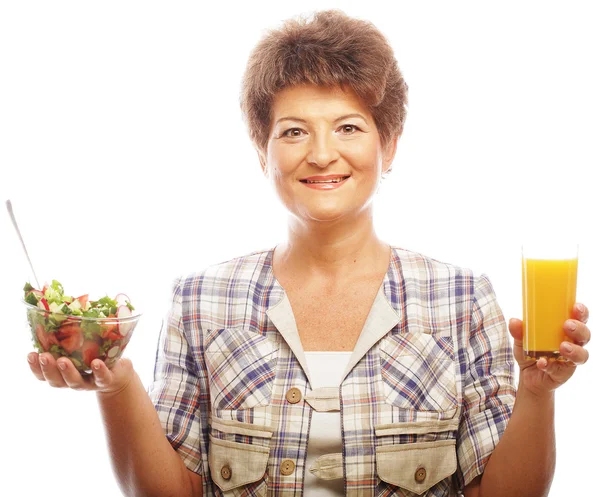 Mature woman with salad and juice — Stock Photo, Image