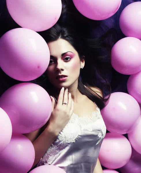 Sleeping woman lying on floor among balloons — Stock Photo, Image