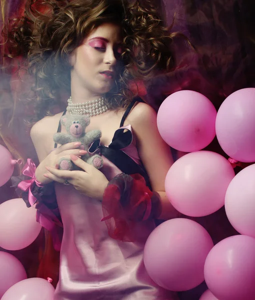 Sleeping woman lying on floor among balloons — Stock Photo, Image