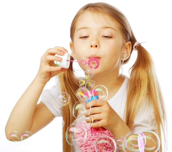 Funny lovely little girl blowing soap bubbles — Stock Photo, Image