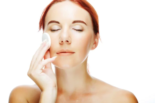 Young woman applying a creme on her face — Stock Photo, Image