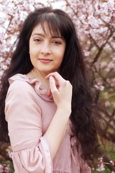 Woman in spring flowers garden — Stock Photo, Image