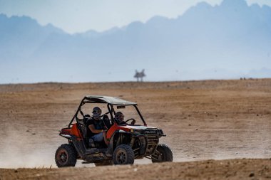 People driving quad bikes during safari trip in Arabian desert not far from Hurghada city, Egypt