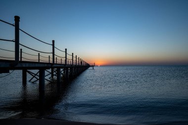 Seascape -view of palm trees, resort beach with sun loungers, umbrellas and the sea. Egypt.
