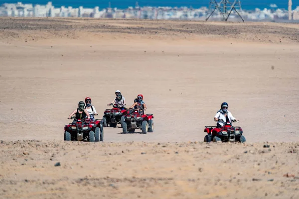 エジプトのフルガダ市から遠くないアラビア砂漠でサファリ旅行中にクワッドバイクを運転する人々 — ストック写真