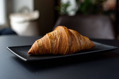 Ayçöreği ve bir fincan çay tarafsız bir arka planda seçici bir odak.